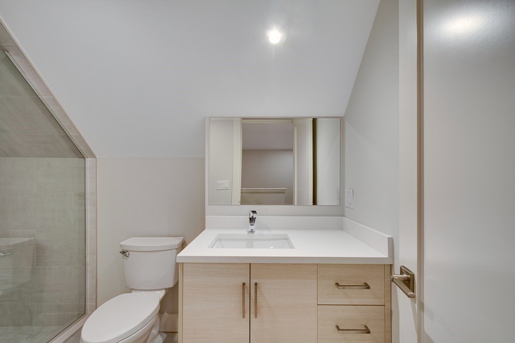 638 Webster Street, Unit 638 Needham, MA 02492 - Photo 22 of 29 a bathroom with a sink toilet and mirror