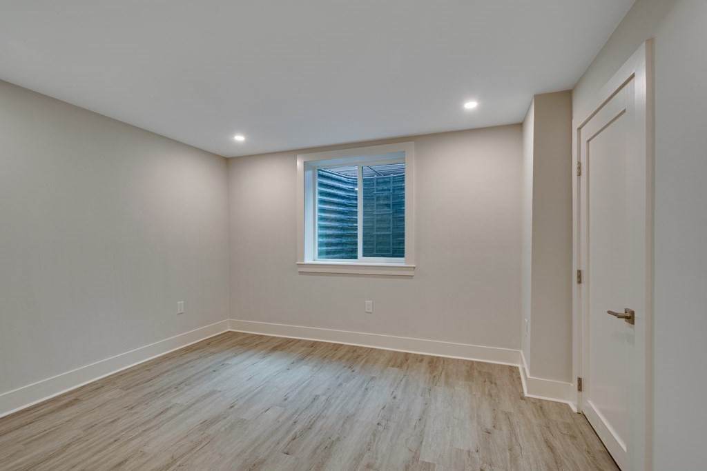 638 Webster Street, Unit 638 Needham, MA 02492 - Photo 25 of 29 wooden floor in an empty room with a window