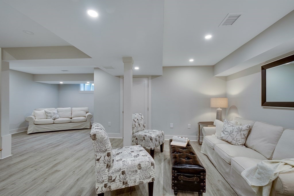 638 Webster Street, Unit 638 Needham, MA 02492 - Photo 26 of 29 a living room with furniture and a wooden floor