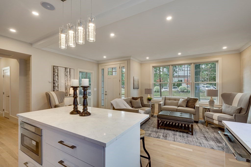 638 Webster Street, Unit 638 Needham, MA 02492 - Photo 8 of 29 a living room with furniture and a chandelier