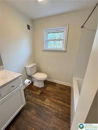 a white toilet sitting next to a bathroom sink