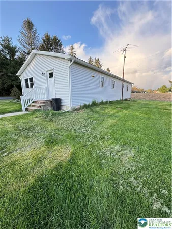 a view of a house with a backyard
