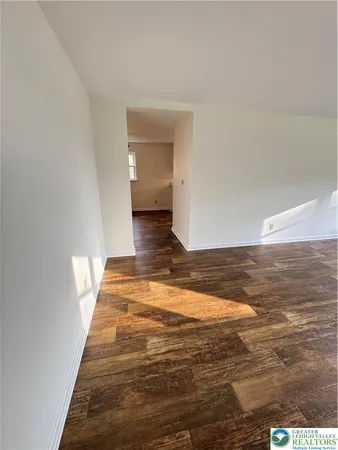 a view of a room with wooden floor