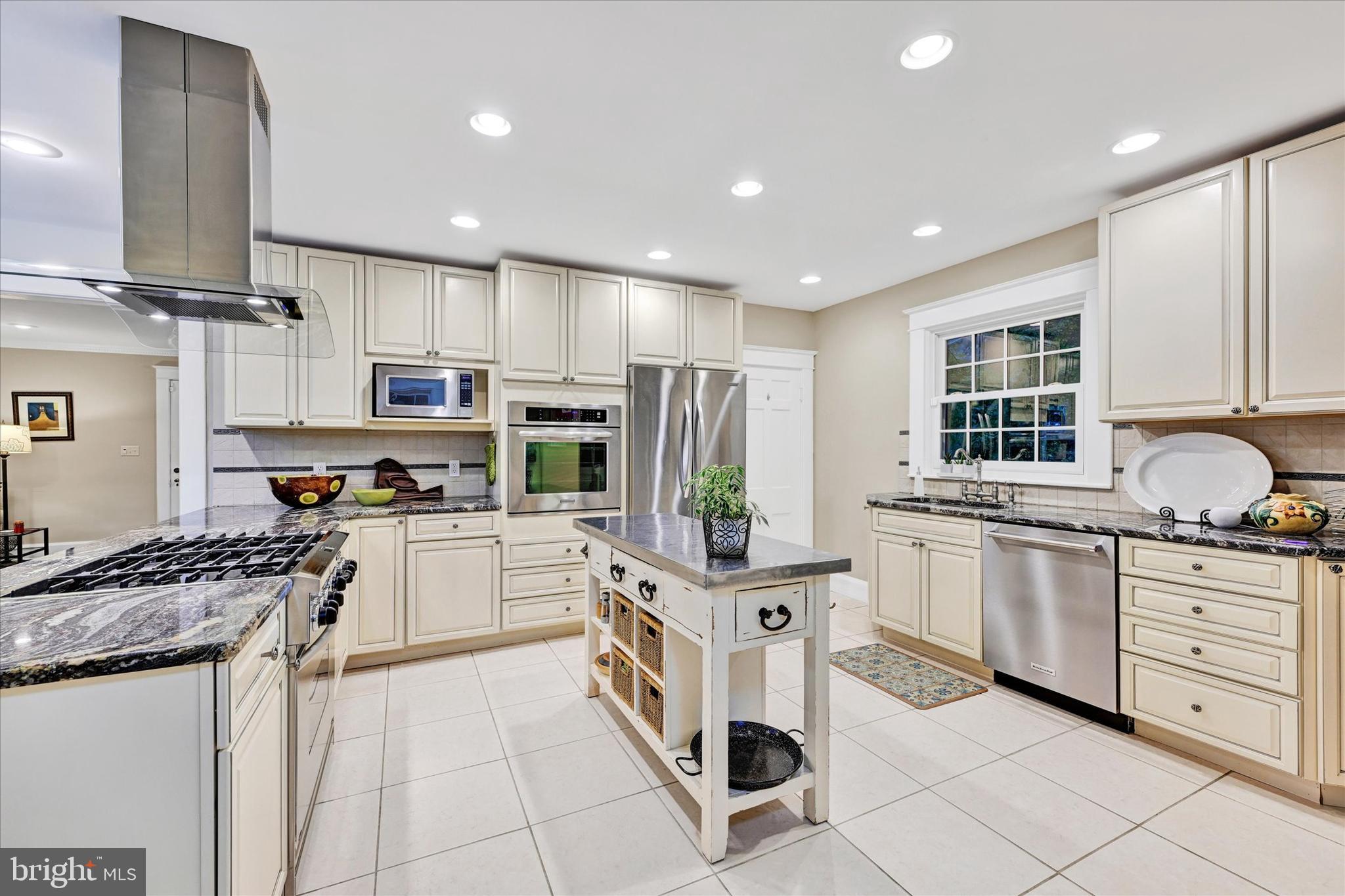 1 Merrymount Road Baltimore, MD 21210 - Photo 18 of 53 a kitchen with stainless steel appliances granite countertop a stove top oven a sink dishwasher a refrigerator and white cabinets with wooden floor