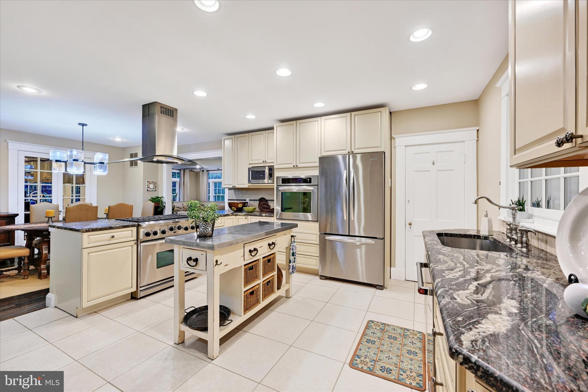 1 Merrymount Road Baltimore, MD 21210 - Photo 19 of 53 a kitchen with stainless steel appliances granite countertop a refrigerator oven a sink and white cabinets