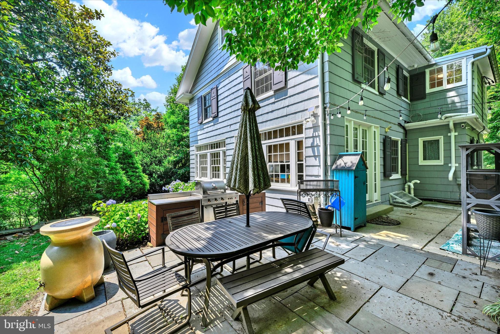 1 Merrymount Road Baltimore, MD 21210 - Photo 2 of 53 a view of a patio with table and chairs and potted plants with large tree