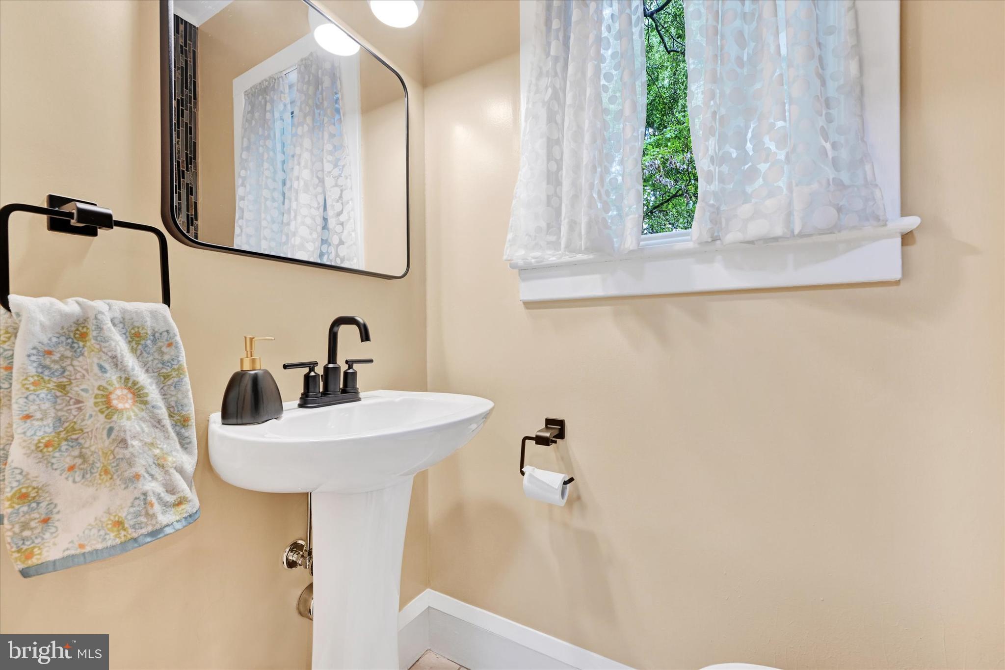 1 Merrymount Road Baltimore, MD 21210 - Photo 22 of 53 a bathroom with a sink and a mirror