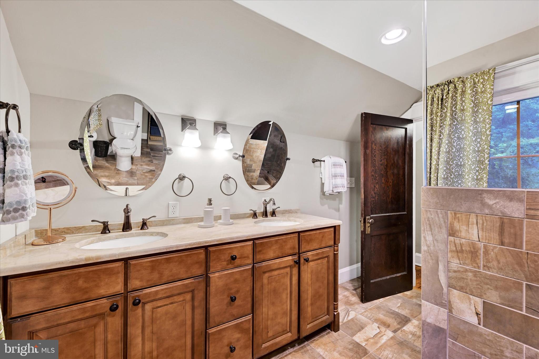 1 Merrymount Road Baltimore, MD 21210 - Photo 36 of 53 a bathroom with a double vanity sink and mirror