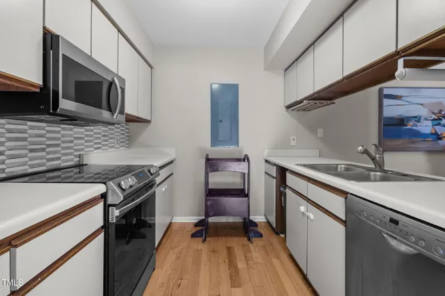 a kitchen with stainless steel appliances granite countertop a stove and a sink