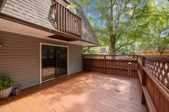a view of backyard with deck and wooden floor