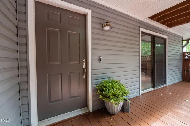 a house with potted plants in front of door