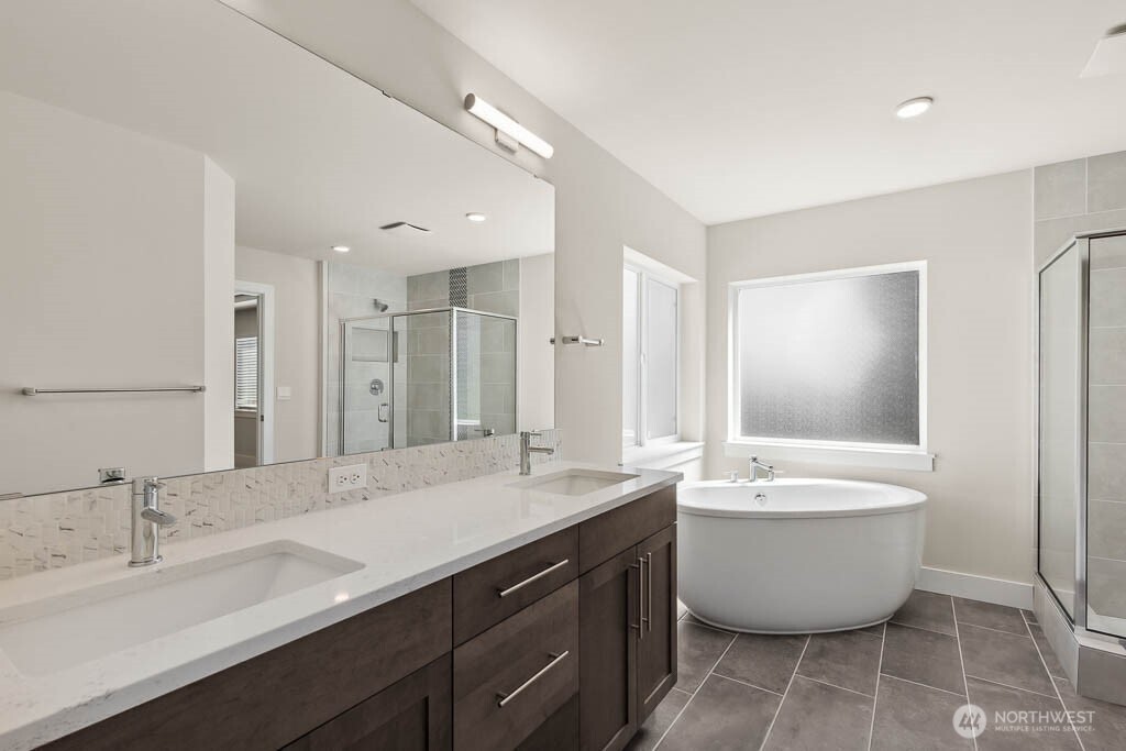 3827 194th Place Southeast Bothell, WA 98012 - Photo 23 of 34 a large bathroom with a double vanity sink mirror and bathtub