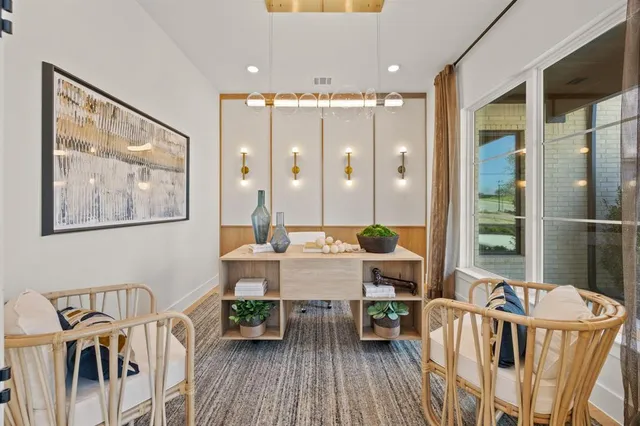 a living room with furniture a large window and wooden floor