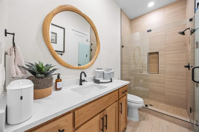 a bathroom with a sink a toilet and a mirror