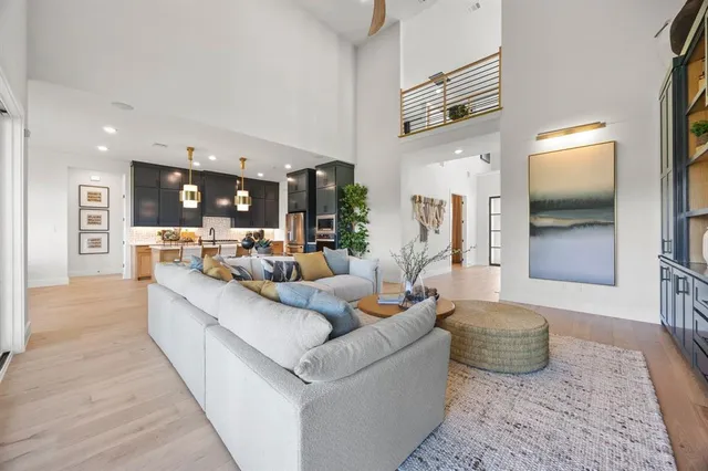 a living room with furniture and kitchen view