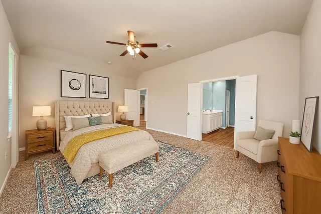 a bedroom with a bed and ceiling fan