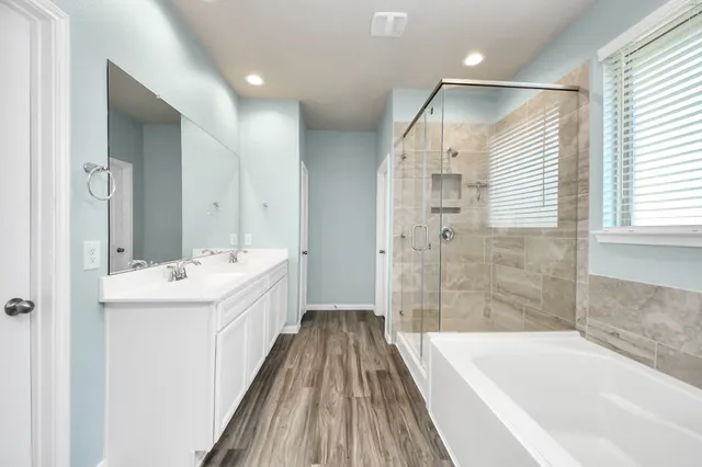a bathroom with a sink a mirror and a bathtub