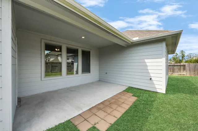 a view of house with backyard