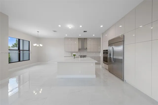 a bathroom with a sink a large mirror and a glass door shower