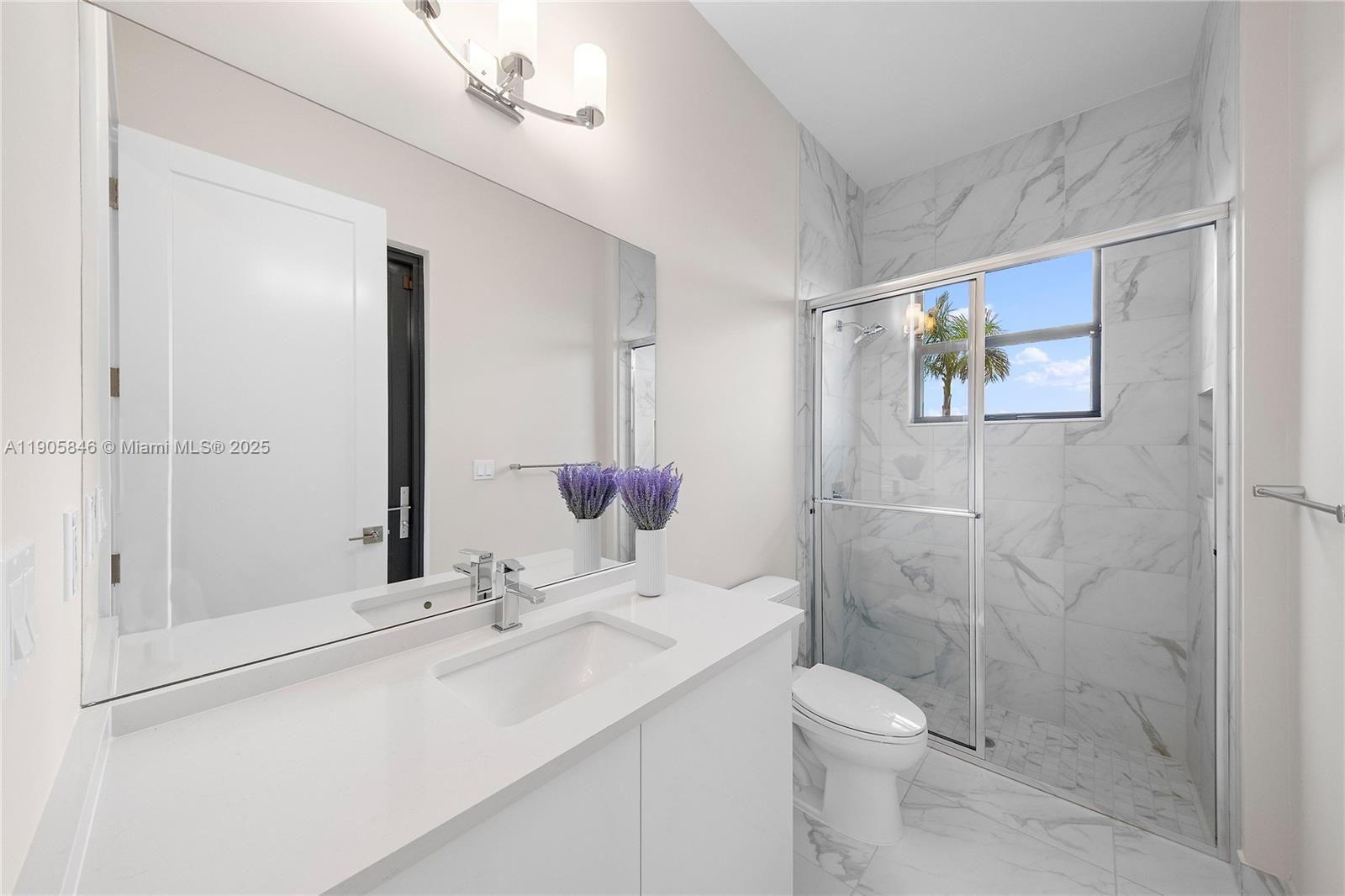 20422 Southernwood Avenue Boca Raton, FL 33434 - Photo 18 of 23 a bathroom with a sink a toilet and shower