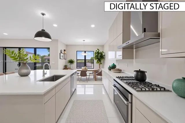 a kitchen with stainless steel appliances a sink a stove and cabinets