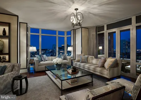 a living room with furniture a rug and a large window