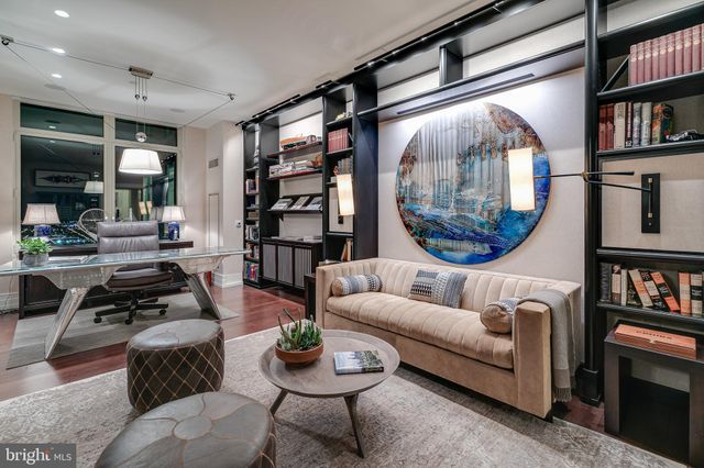 a living room with furniture and a book shelf