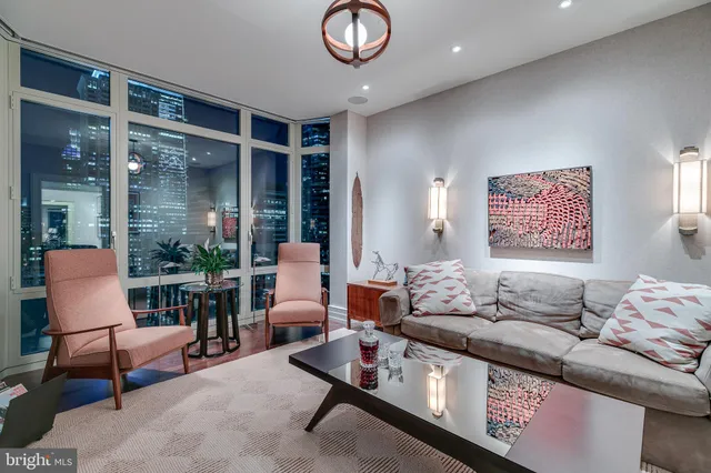 a living room with furniture and a large window