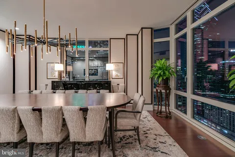 a dining room with furniture and wooden floor