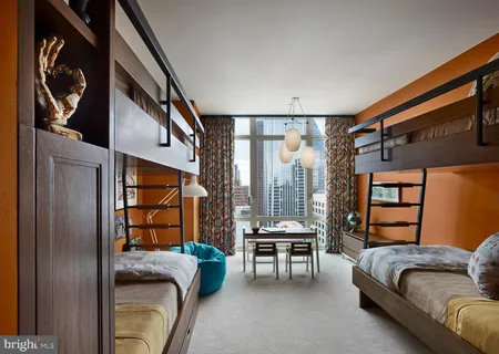 a bedroom with furniture and a window