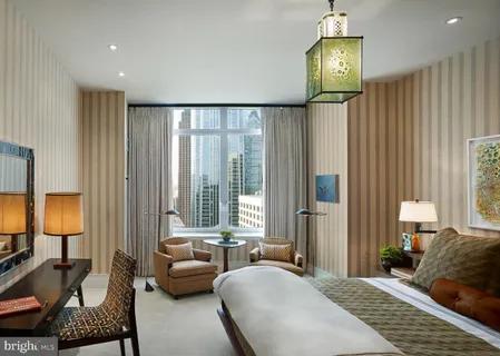 a bedroom with furniture and a window