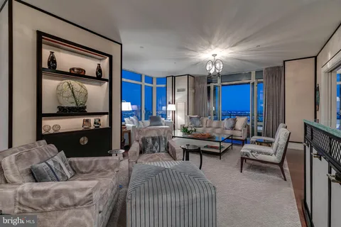 a living room with furniture a lamp and a flat screen tv