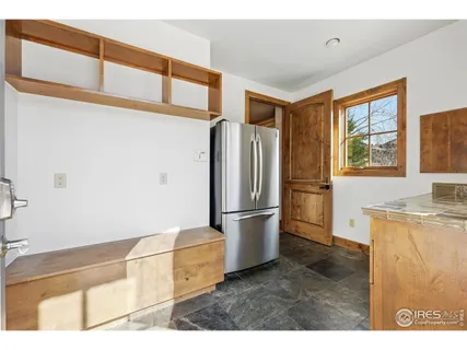 a kitchen with granite countertop a refrigerator and a sink