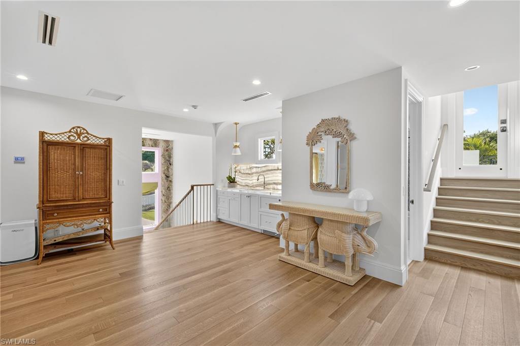 111 Caribbean Road Naples, FL 34108 - Photo 28 of 50 a living room with furniture and a wooden floor