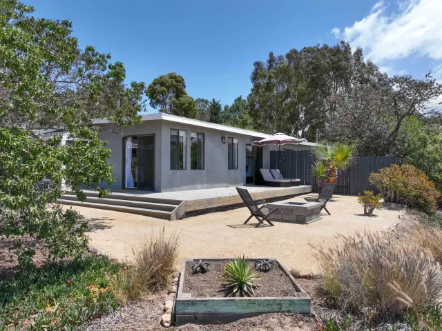 an aerial view of a house with a yard and lake view