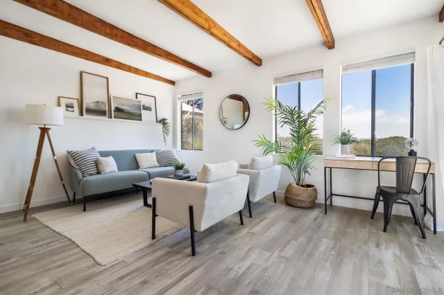 a kitchen with white cabinets stainless steel appliances and wooden floor