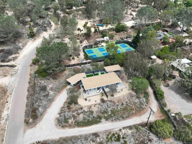 a backyard of a house with fire pit and outdoor seating