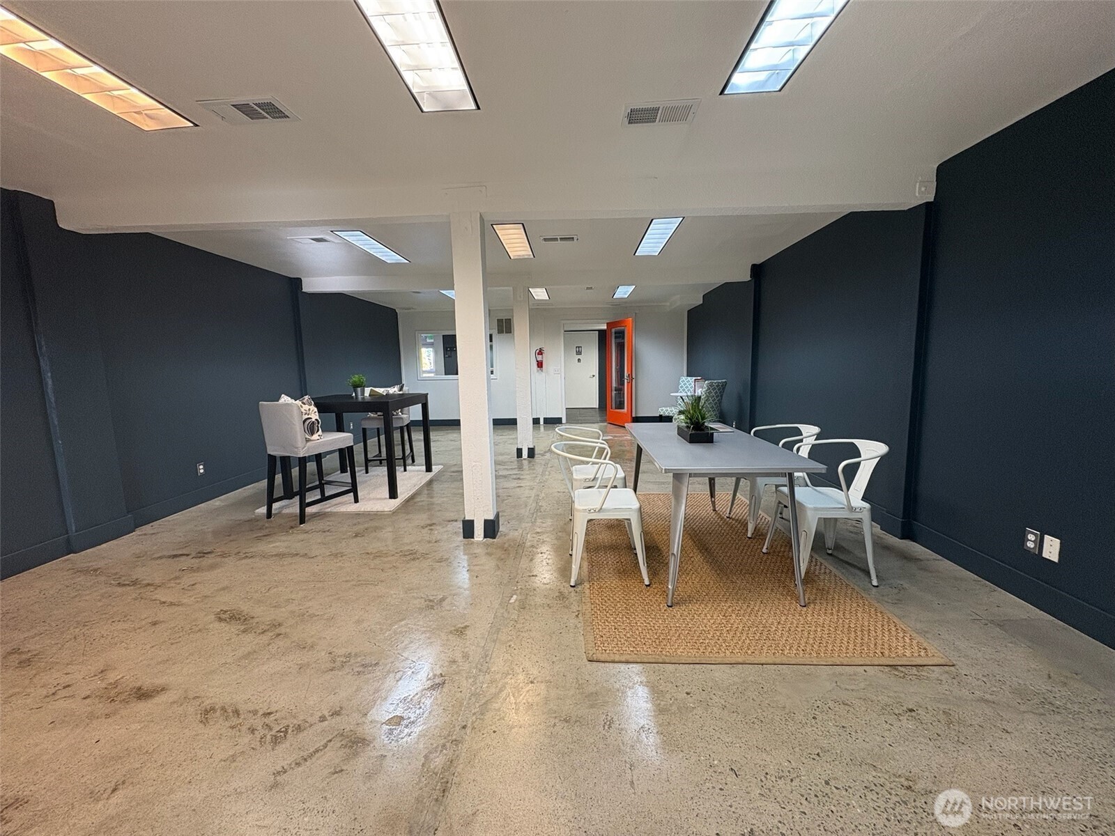 23931 Highway 99, Unit 102 Edmonds, WA 98026 - Photo 12 of 19 a living room with a dining table a table and chairs