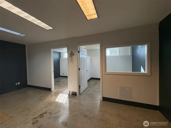 an empty room with windows and closet