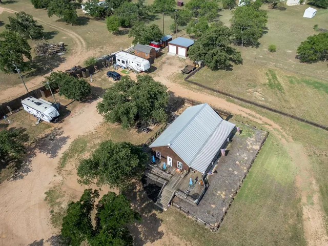 an aerial view of a house with a yard