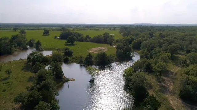 a view of a lake with green space