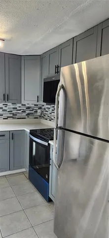 a kitchen with stainless steel appliances granite countertop a sink and a stove