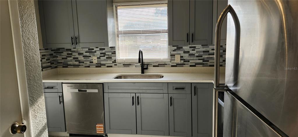 5507 Riddle Road Holiday, FL 34690 - Photo 20 of 20 a sink with a granite countertop window and white cabinets