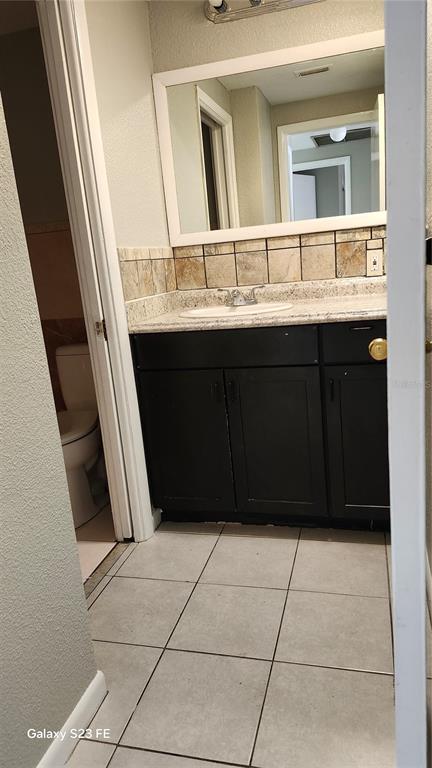 5507 Riddle Road Holiday, FL 34690 - Photo 9 of 20 a bathroom with a vanity and a mirror