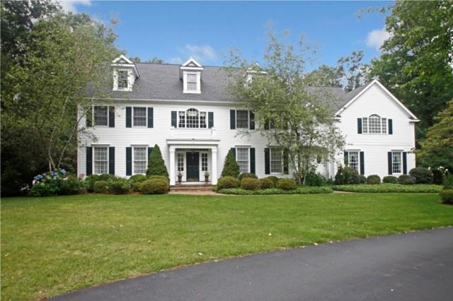 140 Barry Avenue Ridgefield, CT 06877 - Photo 1 of 1 a view of a white house next to a yard with big trees