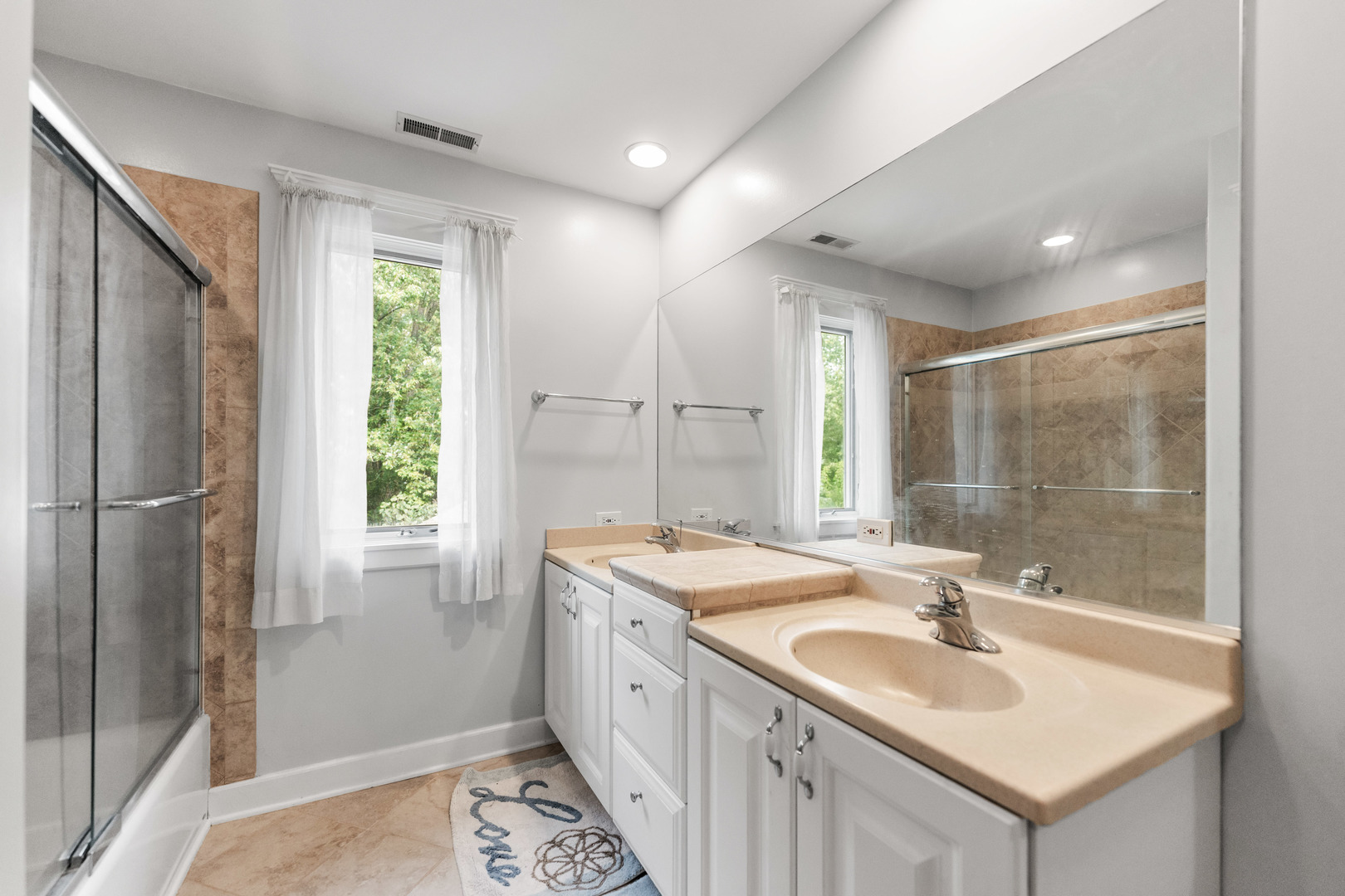 23W620 Walnut Street Roselle, IL 60172 - Photo 37 of 71 a bathroom with a sink double vanity mirror and a shower