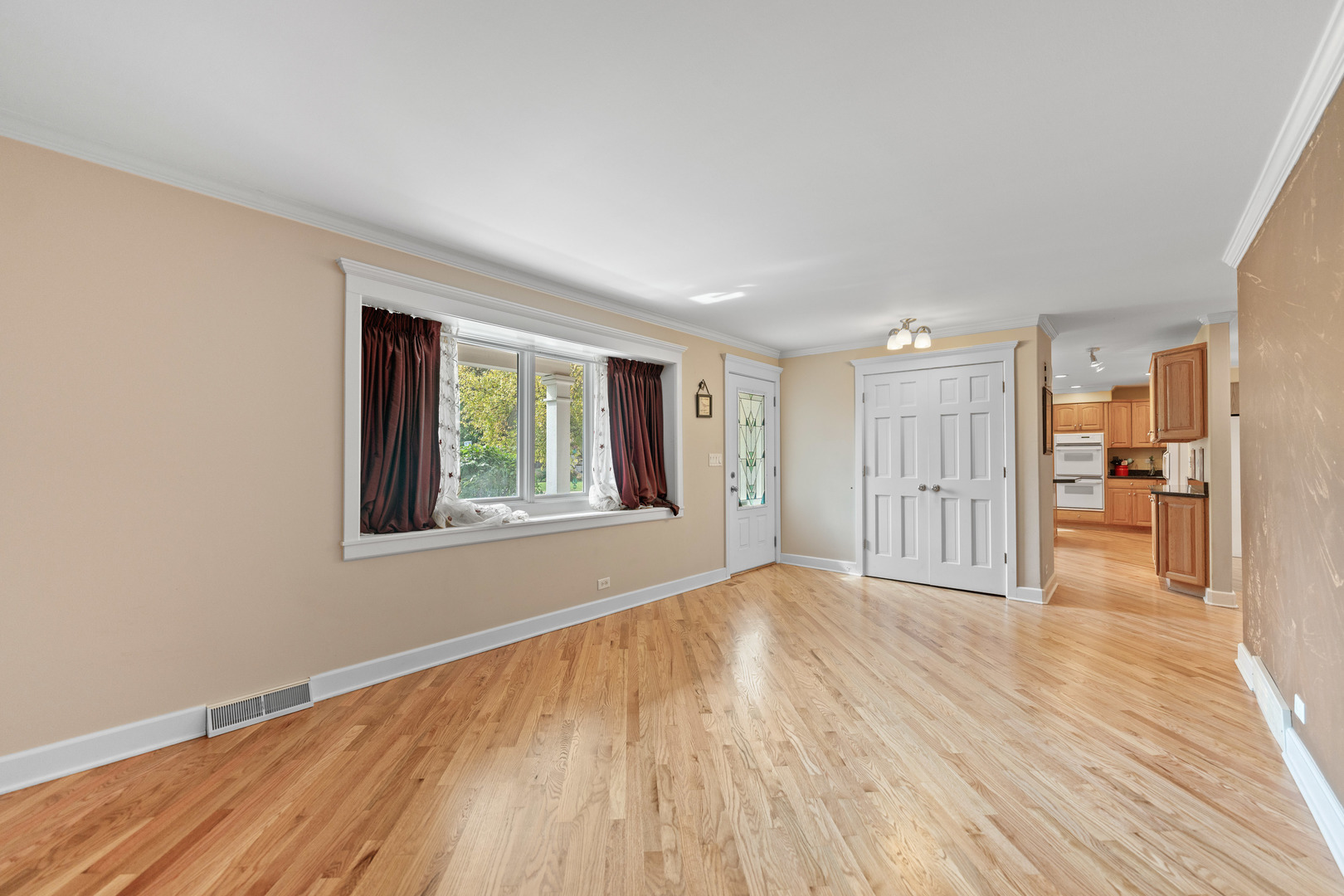 23W620 Walnut Street Roselle, IL 60172 - Photo 5 of 71 a view of an empty room with wooden floor and a window