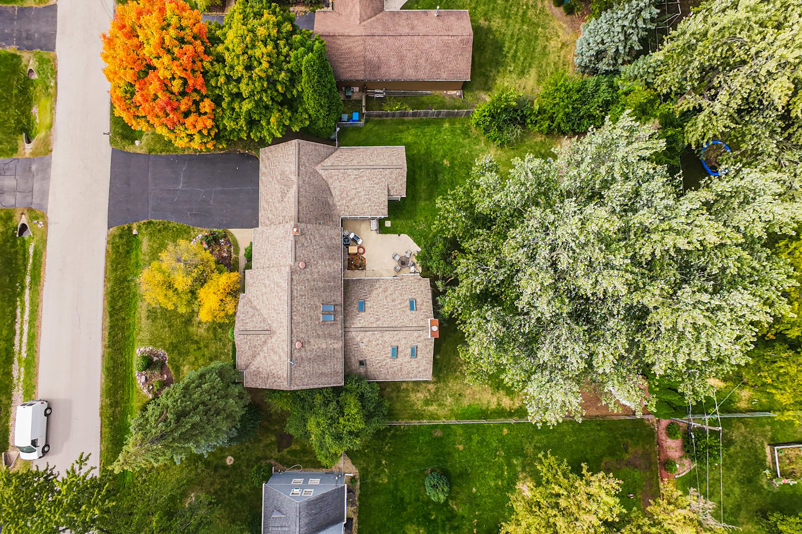 23W620 Walnut Street Roselle, IL 60172 - Photo 63 of 71 an aerial view of a house with a yard lake and trees all around