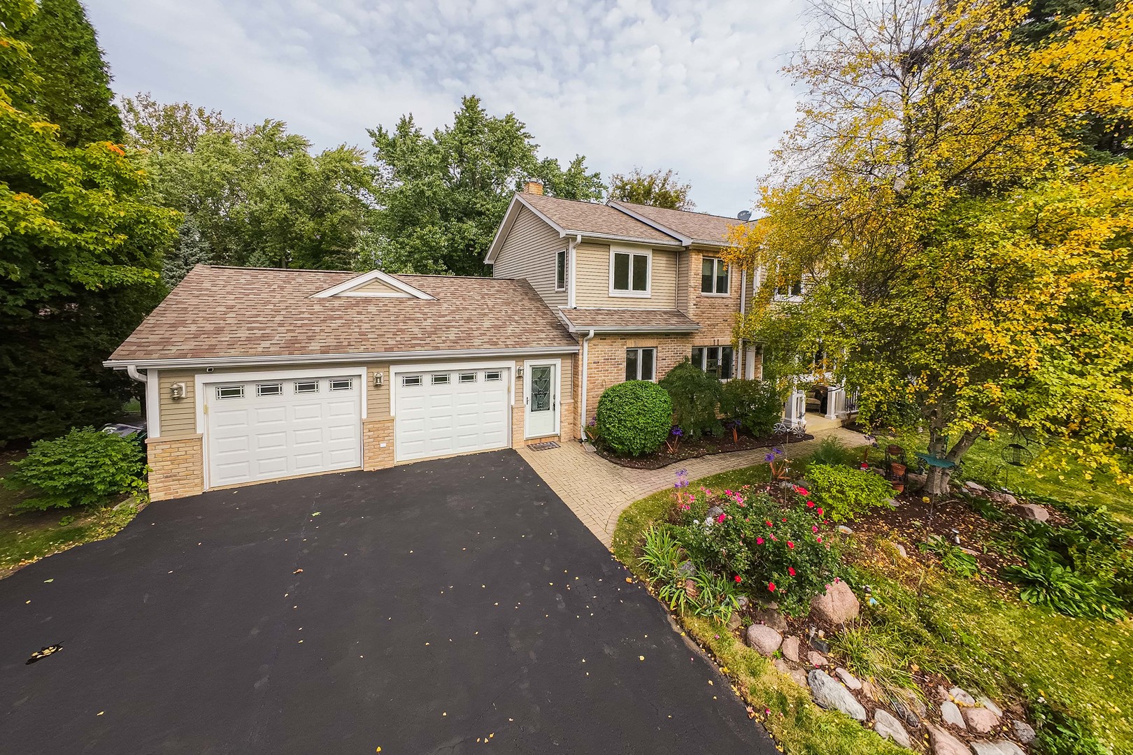 23W620 Walnut Street Roselle, IL 60172 - Photo 67 of 71 a front view of a house with a yard and garage
