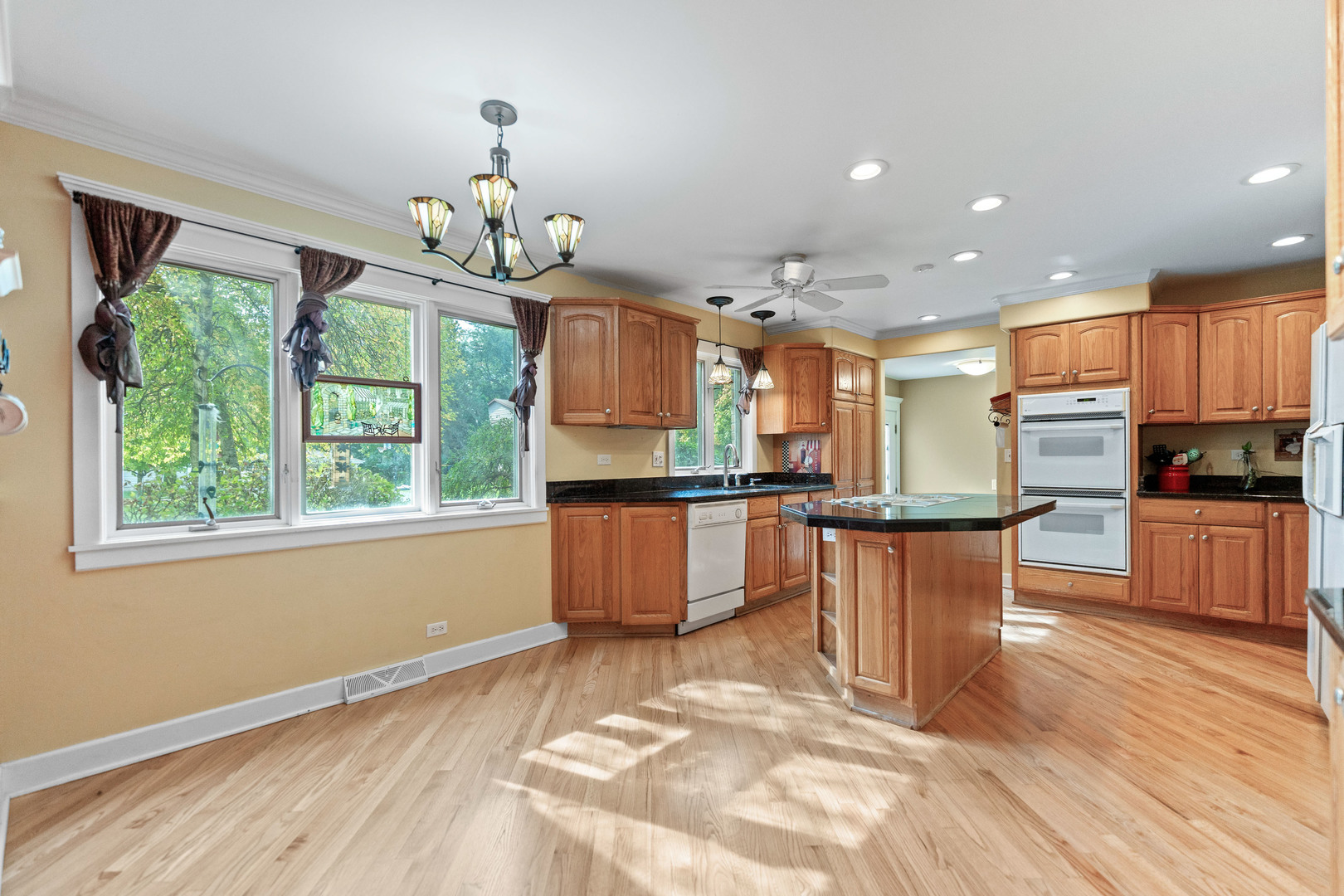 23W620 Walnut Street Roselle, IL 60172 - Photo 9 of 71 a kitchen with stainless steel appliances granite countertop a stove and a wooden floors
